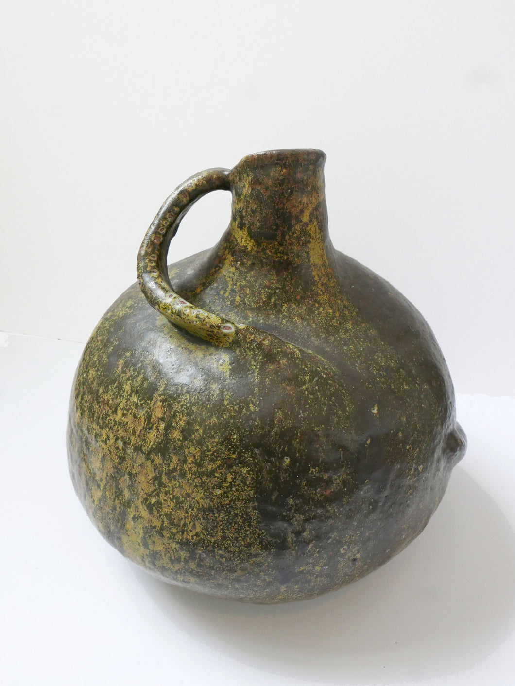 Vintage Stoneware Water Jug for sale. Urn like shape  with abstract detailed handle and a mottled matt glaze with . 
