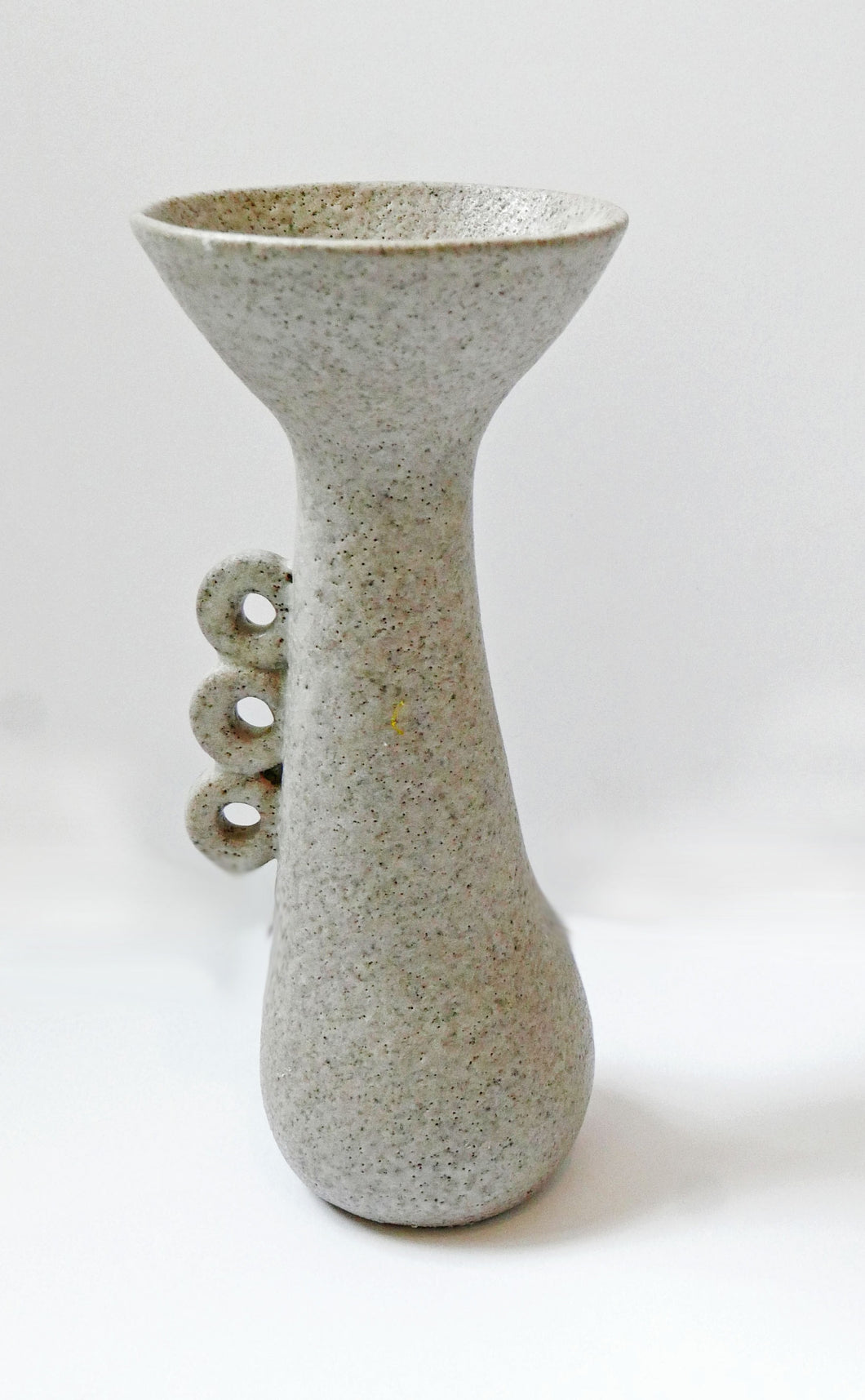Vintage Stoneware vase with a delicate abstract detailed handle and a mottled matt glaze. 