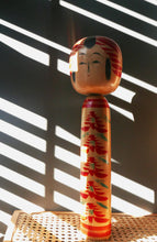 Load image into Gallery viewer, Large wooden Japenese Kokeshi doll for sale. A warm smiling face with hand painted flowers on her body with Japanese script on the base.
